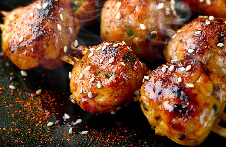 japanese meatball grill or tsukune cooked with teriyaki sauce ready to eat photo in studio lighting